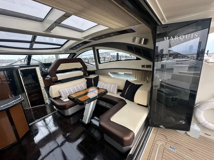  Yacht Photos Pics Luxurious interior of a 2008 Marquis 40 SC yacht with elegant seating and panoramic windows.