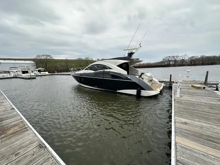  Yacht Photos Pics 2008 Marquis 40 SC yacht docked in a marina under cloudy skies.