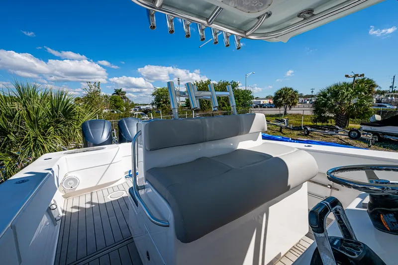  Yacht Photos Pics 2015 SeaHunter 37 Tournament boat interior with seating and steering wheel, under a clear blue sky.