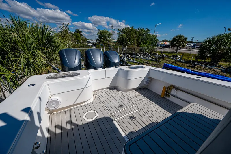  Yacht Photos Pics 2015 SeaHunter 37 Tournament boat deck with triple outboard motors, under a clear blue sky.