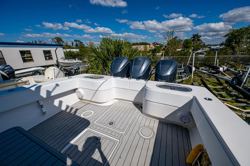  Yacht Photos Pics 2015 SeaHunter 37 Tournament boat with triple outboard engines, spacious deck, and clear skies.