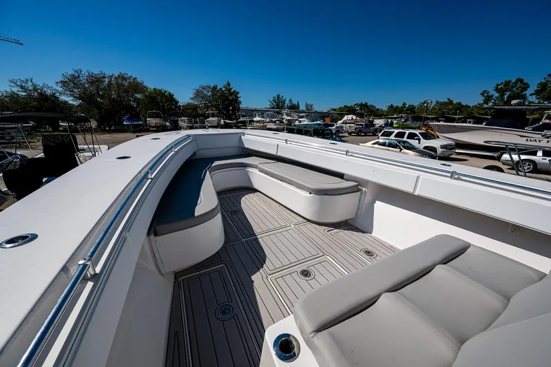  Yacht Photos Pics 2015 SeaHunter 37 Tournament boat deck with seating, parked outdoors under clear blue sky.