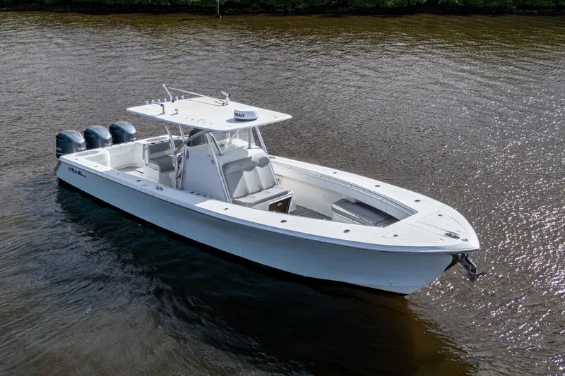  Yacht Photos Pics 2015 SeaHunter 37 Tournament boat on calm water, featuring triple outboard engines.