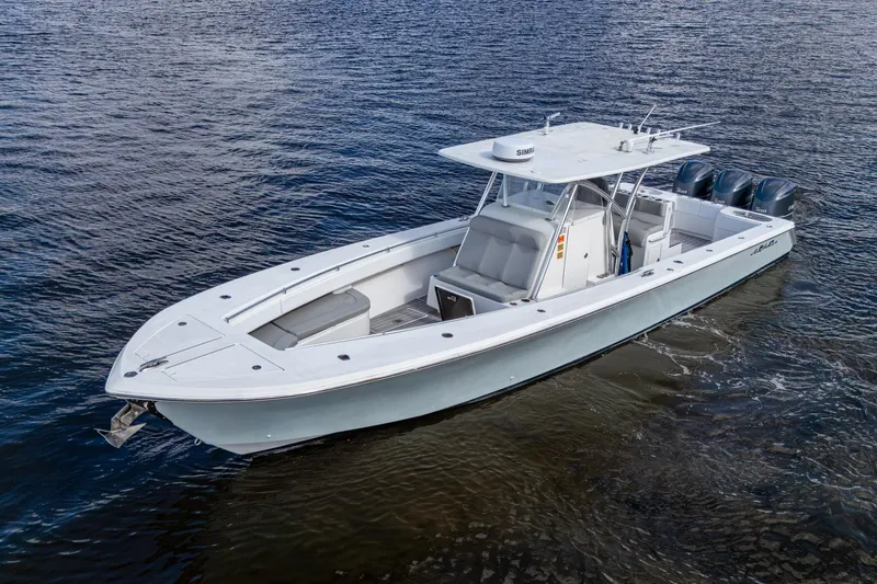  Yacht Photos Pics 2015 SeaHunter 37 Tournament boat on water, featuring sleek design and triple outboard engines.