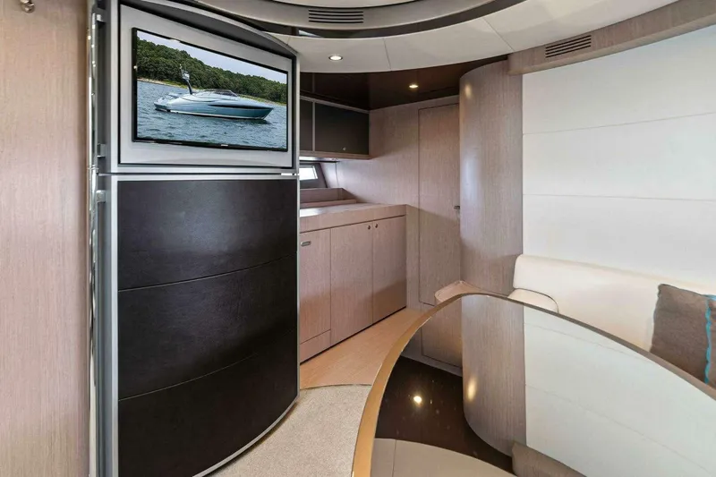  Yacht Photos Pics Luxurious interior of 2016 Riva 52' Rivale yacht with modern furnishings and TV display.