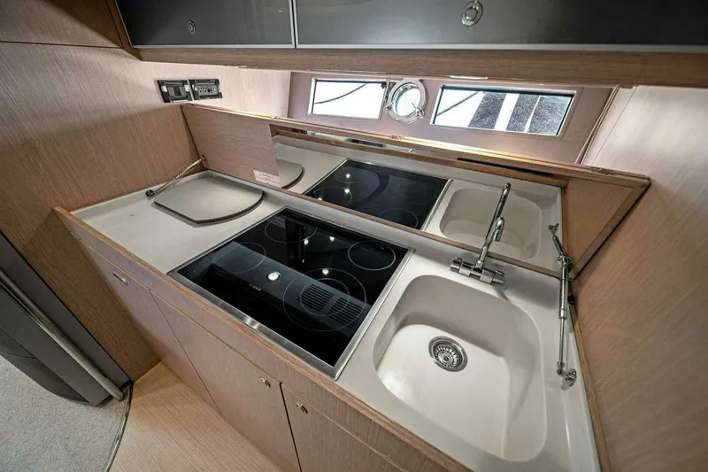  Yacht Photos Pics Modern kitchen interior of 2016 Riva 52' Rivale yacht with sleek appliances and sink.