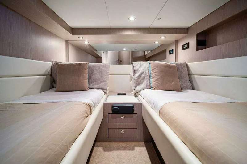  Yacht Photos Pics Luxurious twin cabin interior of 2016 Riva 52' Rivale yacht, featuring elegant bedding and lighting.