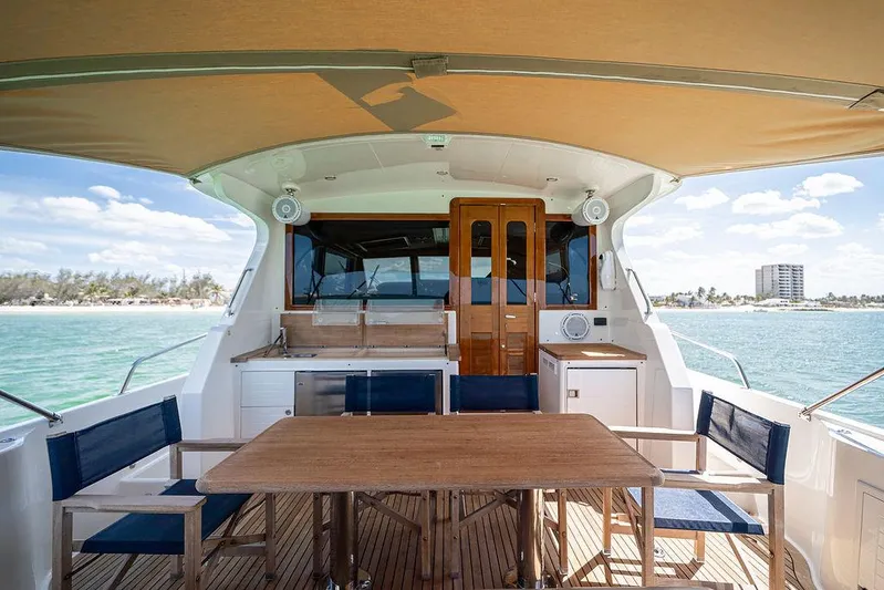 Compass Yacht Photos Pics Luxurious 2020 Grand Banks 44 Eastbay SX yacht with elegant outdoor dining area.