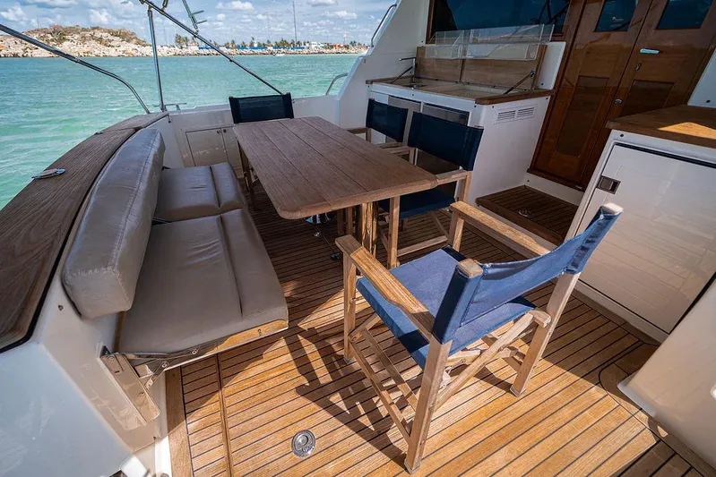 Compass Yacht Photos Pics 2020 Grand Banks 44 Eastbay SX yacht deck with wooden seating and ocean view.