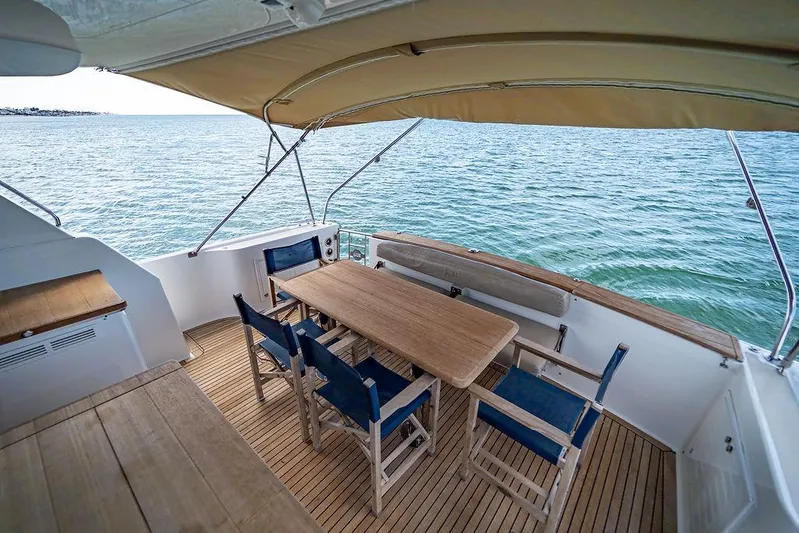Compass Yacht Photos Pics Grand Banks 44 Eastbay SX 2020 yacht deck with dining area overlooking the ocean.