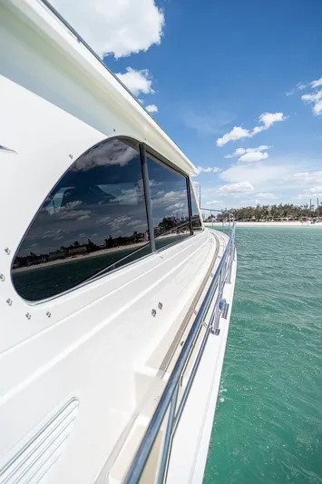 Compass Yacht Photos Pics 2020 Grand Banks 44 Eastbay SX yacht cruising on clear turquoise waters under a blue sky.