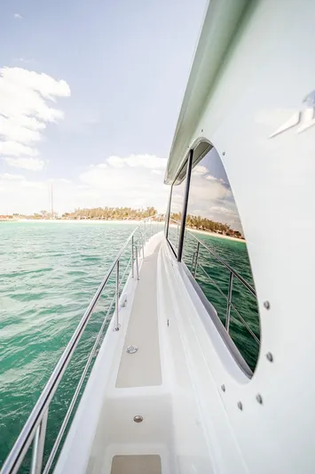 Compass Yacht Photos Pics Side view of 2020 Grand Banks 44 Eastbay SX yacht on turquoise water.