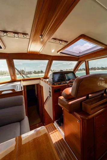 Compass Yacht Photos Pics Interior of 2020 Grand Banks 44 Eastbay SX yacht with luxurious wood finish and navigation controls.