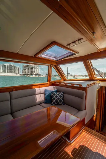 Compass Yacht Photos Pics Interior of 2020 Grand Banks 44 Eastbay SX yacht with elegant wood finish and waterfront view.