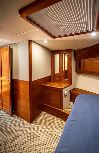 Compass Yacht Photos Pics Interior of 2020 Grand Banks 44 Eastbay SX yacht with wood paneling and cozy furnishings.