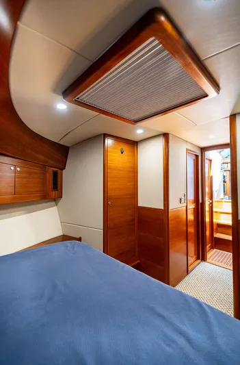 Compass Yacht Photos Pics Interior cabin of 2020 Grand Banks 44 Eastbay SX with wooden finishes and cozy bed.