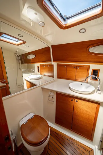 Compass Yacht Photos Pics Luxurious bathroom in 2020 Grand Banks 44 Eastbay SX yacht with wood accents and modern fixtures.