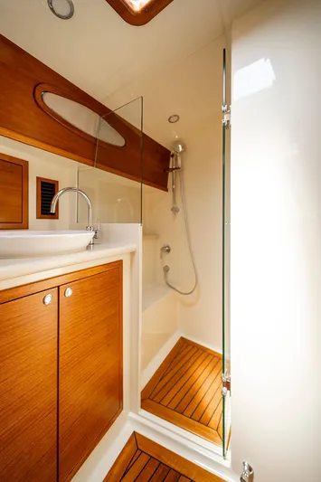 Compass Yacht Photos Pics Luxurious bathroom in 2020 Grand Banks 44 Eastbay SX yacht with wood accents and modern fixtures.