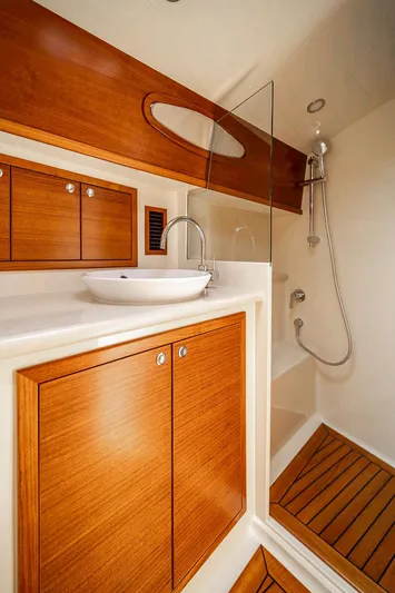 Compass Yacht Photos Pics Luxurious bathroom in 2020 Grand Banks 44 Eastbay SX yacht with wood accents and modern fixtures.