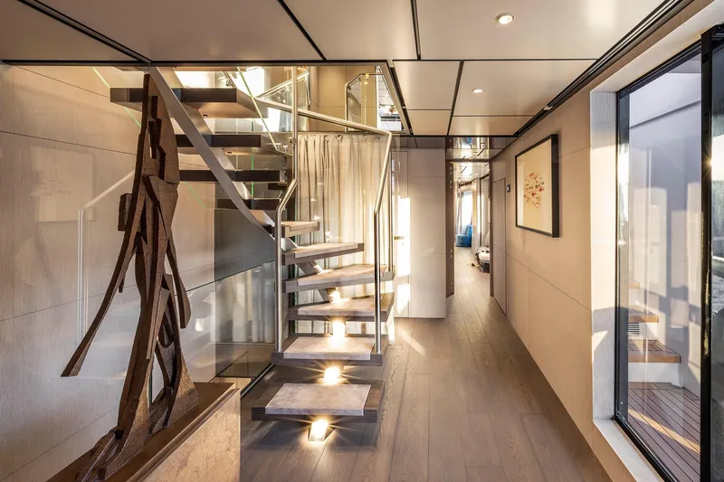 Miotu Yacht Photos Pics Luxurious interior of 2022 Custom Line CL 140 yacht with modern staircase and elegant decor.