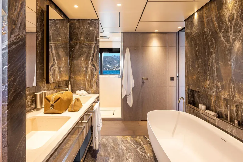 Miotu Yacht Photos Pics Luxurious bathroom in 2022 Custom Line CL 140 yacht with marble accents and modern fixtures.