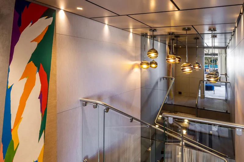 Miotu Yacht Photos Pics Modern interior of Custom Line CL 140 yacht, featuring vibrant artwork and elegant lighting, 2022 model.