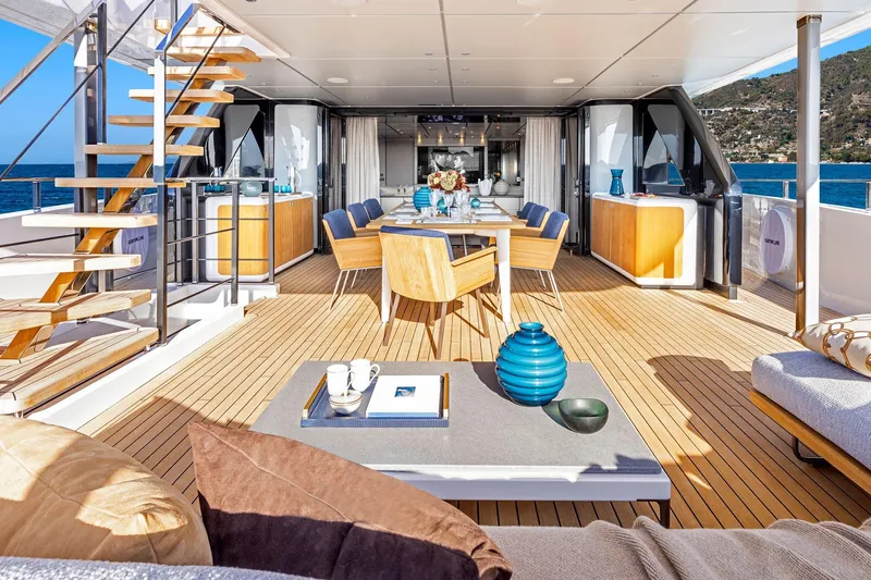 Miotu Yacht Photos Pics Luxurious 2022 Custom Line CL 140 yacht deck with elegant dining area and ocean view.
