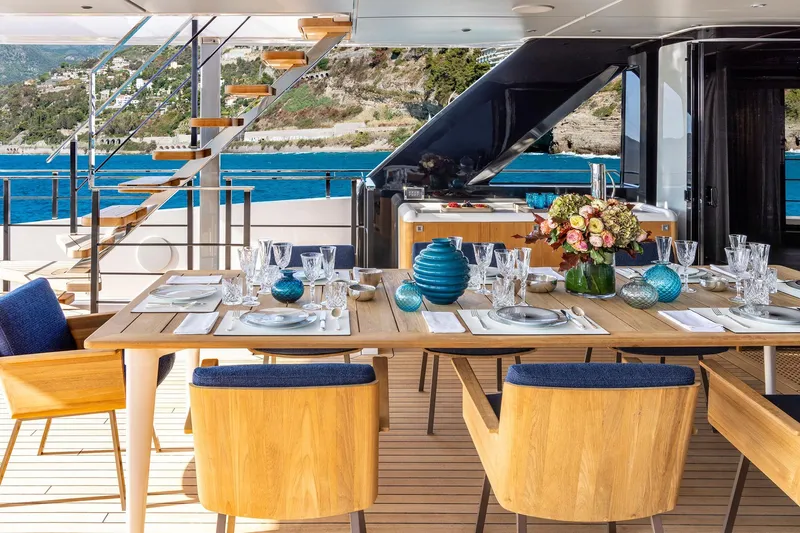 Miotu Yacht Photos Pics Luxurious dining setup on Custom Line CL 140 yacht, 2022, with ocean view.