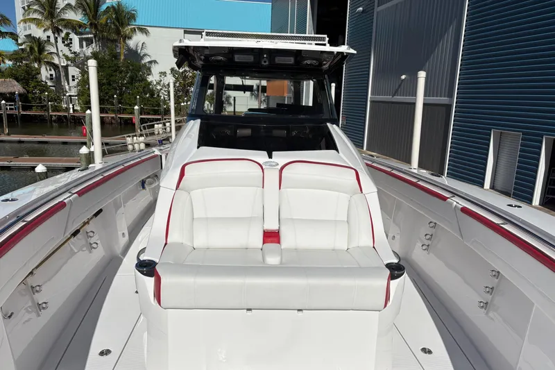  Yacht Photos Pics 2022 Nor-Tech 452 Super Fish boat with white and red seating, docked near a marina.