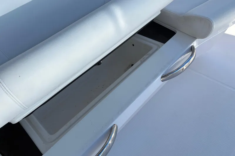  Yacht Photos Pics 2022 Nor-Tech 452 Super Fish boat storage compartment with white cushioned seating.