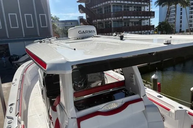  Yacht Photos Pics 2022 Nor-Tech 452 Super Fish boat with Garmin equipment, docked near modern buildings.