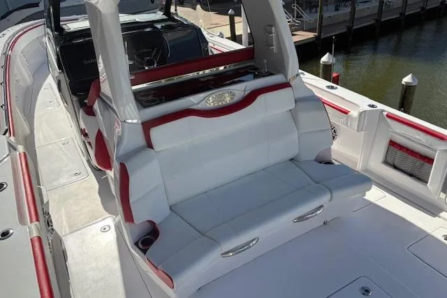  Yacht Photos Pics 2022 Nor-Tech 452 Super Fish boat with white and red seating, docked by the water.