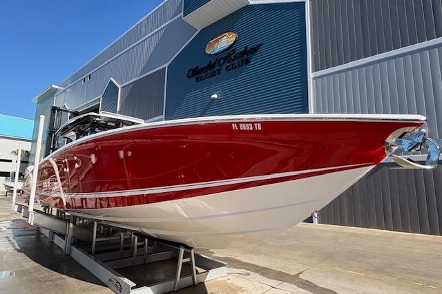 2022 Nor-Tech 452 Super Fish boat with red hull, docked at a marina.