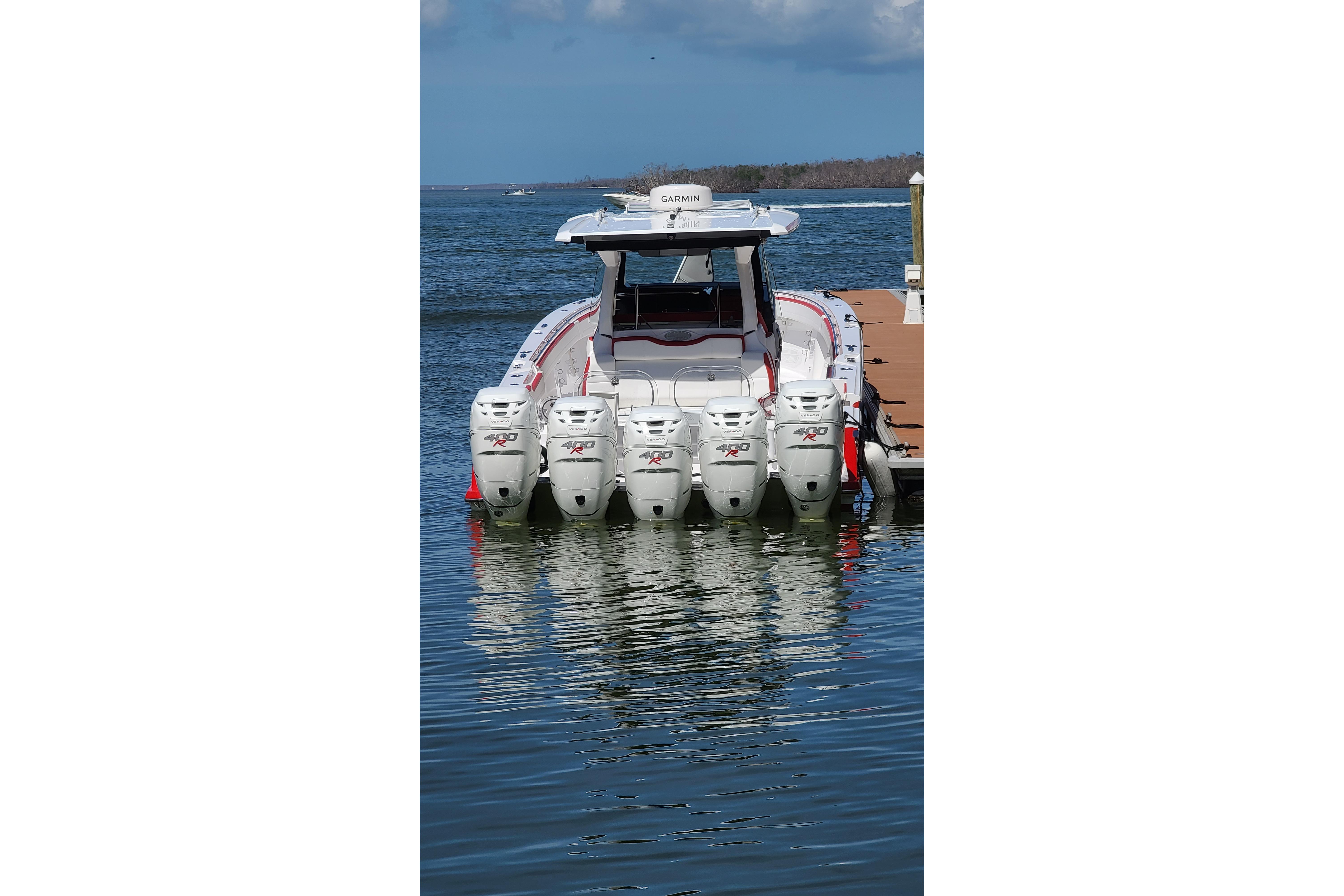 2022 Nor-Tech 452 Super Fish boat with five powerful outboard engines docked on water.