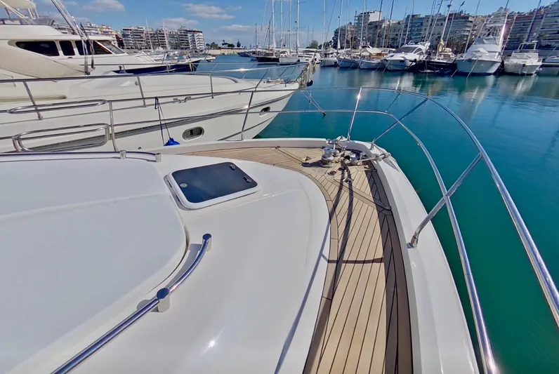  Yacht Photos Pics Fairline Squadron 52 yacht deck, 2000 model, docked in a marina with clear blue water.