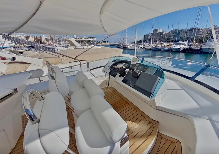  Yacht Photos Pics Luxurious 2000 Fairline Squadron 52 yacht helm with white seating and marina view.