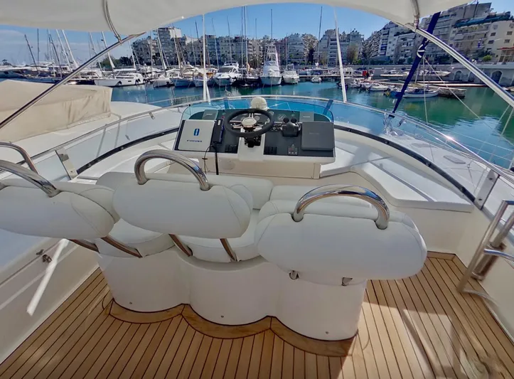  Yacht Photos Pics Flybridge of 2000 Fairline Squadron 52 yacht with helm, white seats, and marina view.