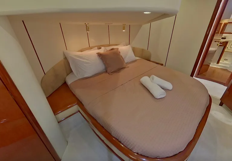  Yacht Photos Pics Luxurious cabin interior of 2000 Fairline Squadron 52 yacht with cozy bed and elegant decor.