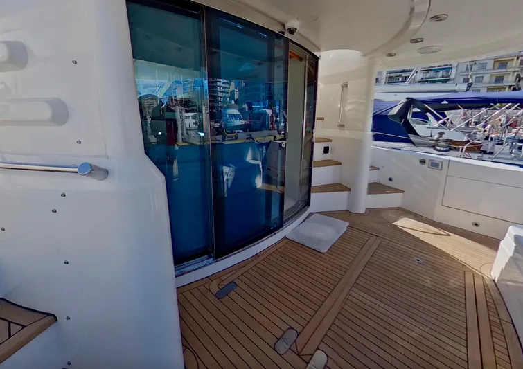  Yacht Photos Pics Fairline Squadron 52 yacht deck, 2000 model, featuring wooden flooring and glass doors.