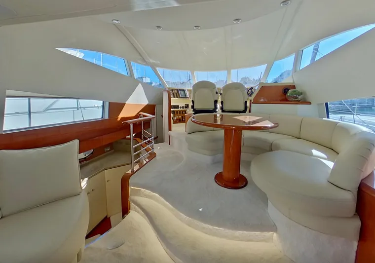  Yacht Photos Pics Luxurious interior of 2000 Fairline Squadron 52 yacht with elegant seating and helm station.