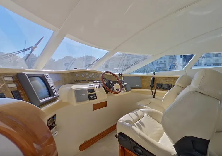  Yacht Photos Pics Helm of 2000 Fairline Squadron 52 yacht with modern navigation equipment and luxurious seating.