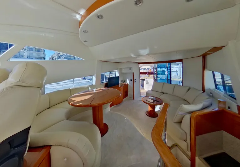  Yacht Photos Pics Luxurious interior of 2000 Fairline Squadron 52 yacht with elegant seating and wooden accents.