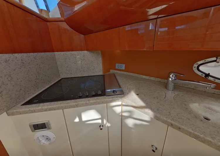 Yacht Photos Pics Fairline Squadron 52 yacht kitchen with stove, sink, and wooden cabinets, 2000 model.