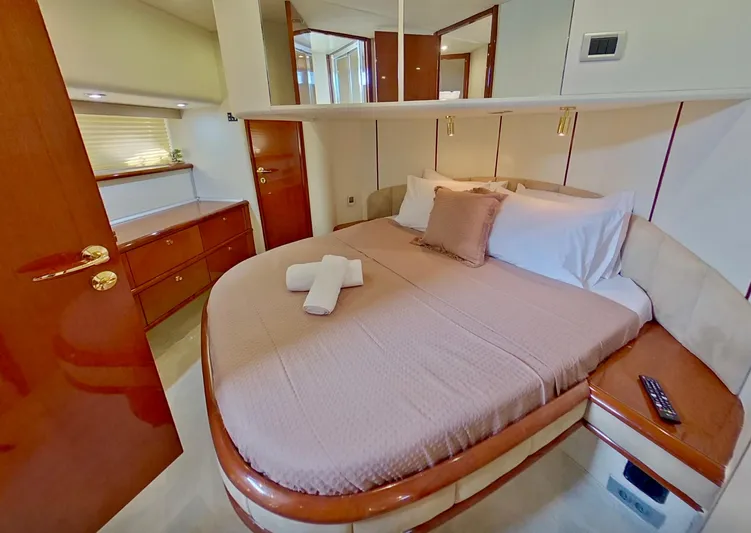  Yacht Photos Pics Luxurious cabin interior of 2000 Fairline Squadron 52 yacht with cozy bed and elegant wood finishes.