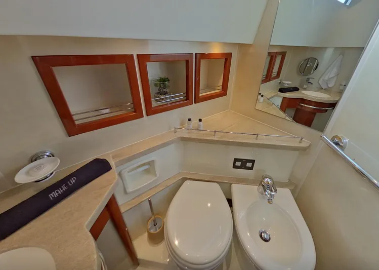  Yacht Photos Pics Luxurious bathroom in 2000 Fairline Squadron 52 yacht with modern fixtures and elegant design.