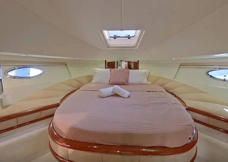  Yacht Photos Pics Luxurious cabin interior of 2000 Fairline Squadron 52 yacht with elegant bedding.