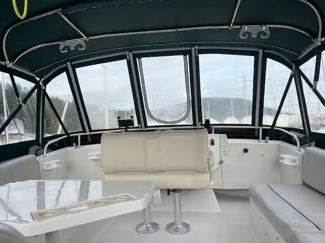  Yacht Photos Pics 2000 Mainship 430 Trawler interior with seating and table, featuring panoramic windows.