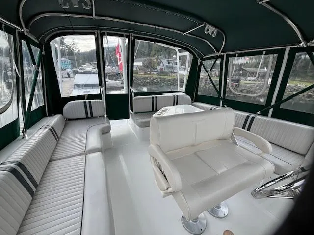  Yacht Photos Pics Interior of 2000 Mainship 430 Trawler with white seating and green canopy.