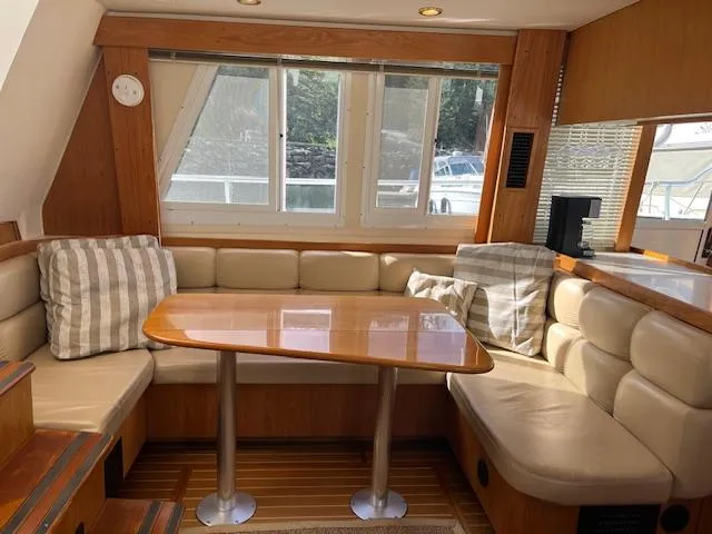  Yacht Photos Pics 2000 Mainship 430 Trawler interior with cozy seating and wooden table.