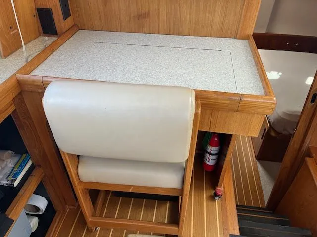  Yacht Photos Pics Mainship 430 Trawler 2000 interior with desk, chair, and fire extinguisher.